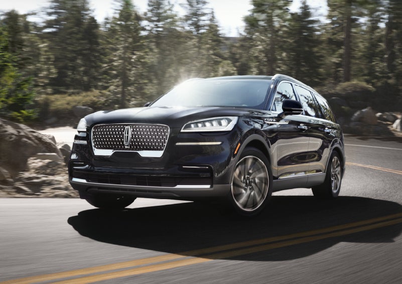 A Lincoln Aviator® SUV is being driven on a winding mountain road | Empire Lincoln of Huntington in Huntington NY