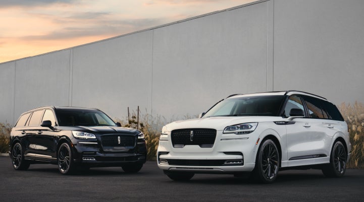 Two Lincoln Aviator® SUVs are shown with the available Jet Appearance Package | Empire Lincoln of Huntington in Huntington NY